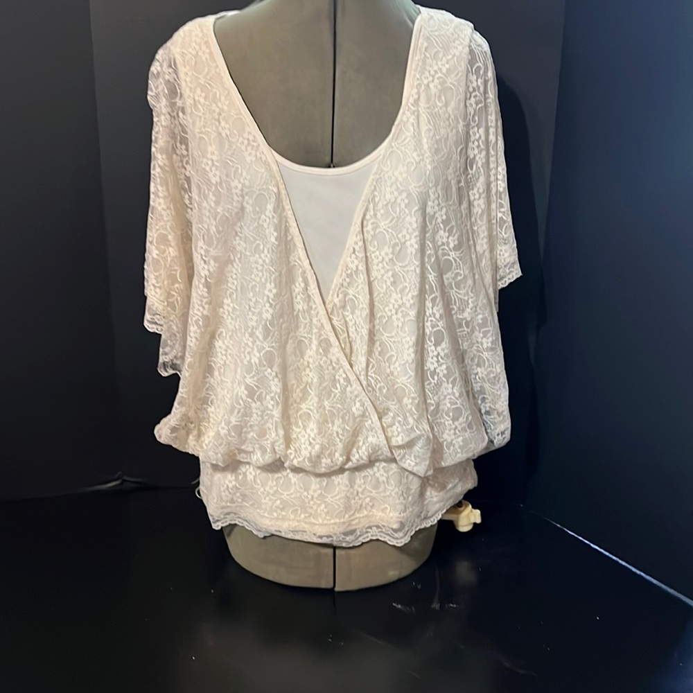 Cream colored lacy top with fitted band around hips. Size large.